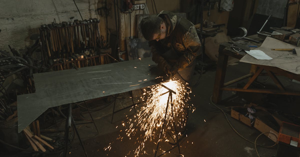 a welder in a workshop creating sparks while working on a metal sheet