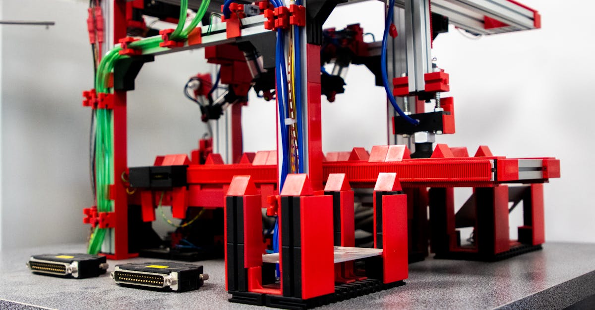 close up view of a robotic assembly machine with vibrant red and metallic components